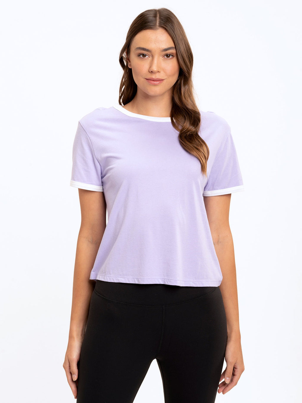 Women wearing a retro-inspired cropped white ringer tee paired with high-waisted leggings.