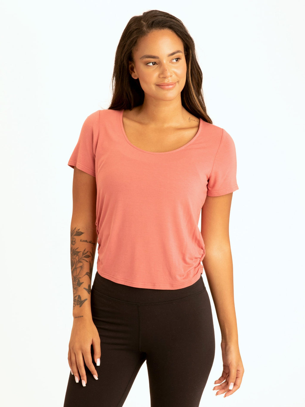 Woman wearing a dusty-rose ruched shirttail cropped tee made from soft modal jersey.