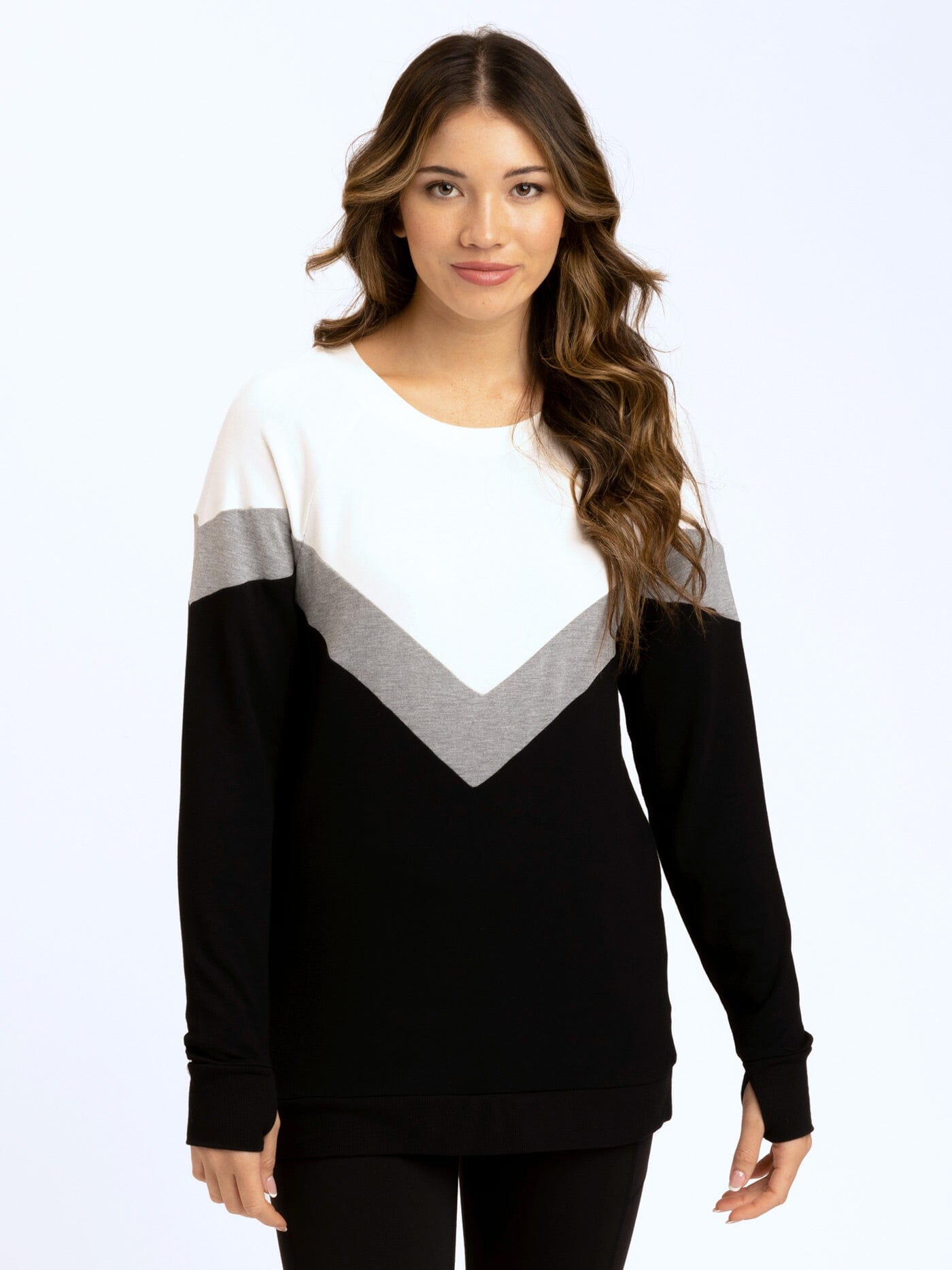 Women wearing a chevron colorblock tunic with tulip hem in black, white, and gray.