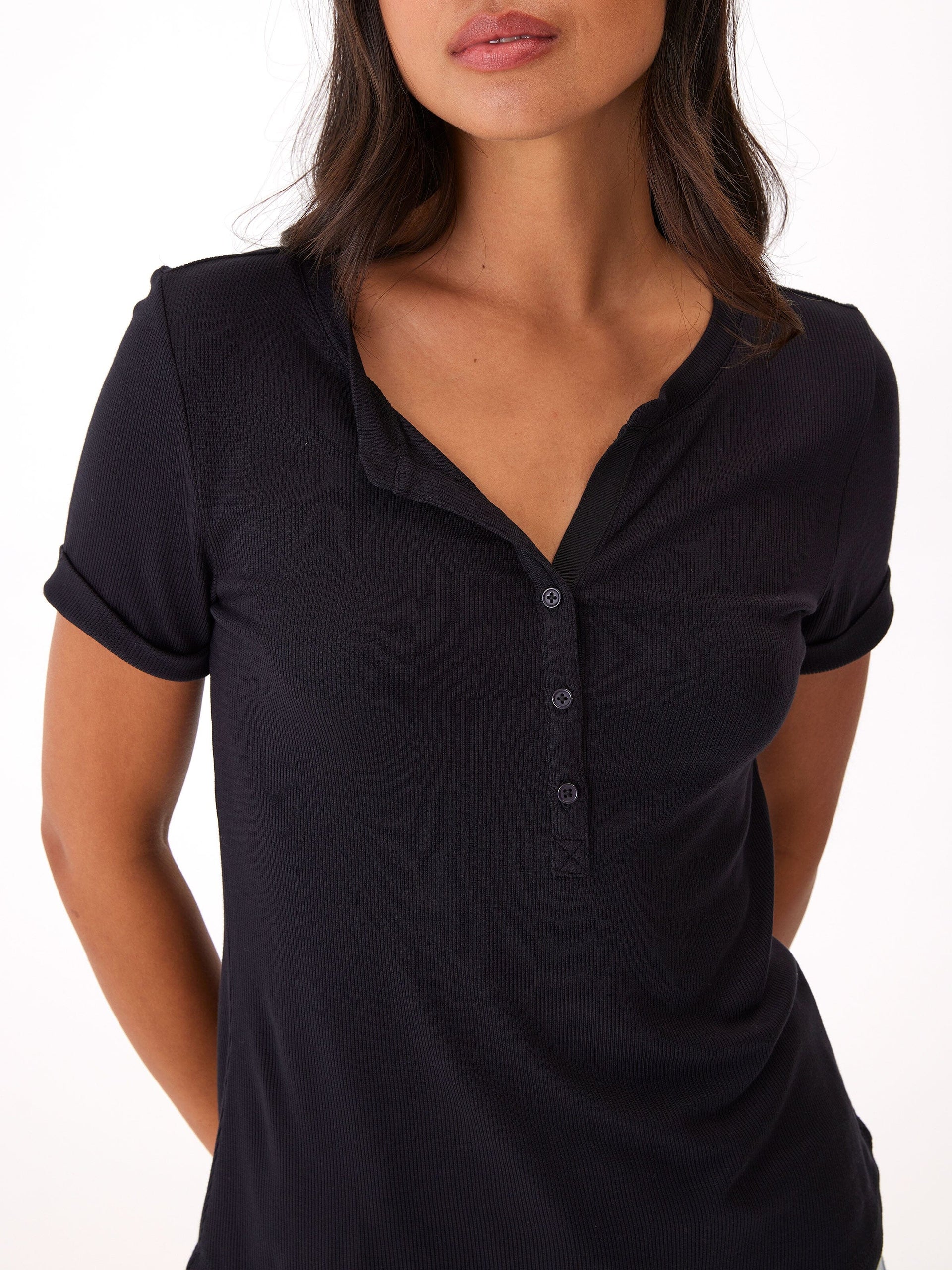 Close-up of the Akia Feather Rib Henley Tee showing ribbed texture, 3-button placket, and cuffed sleeve detail.