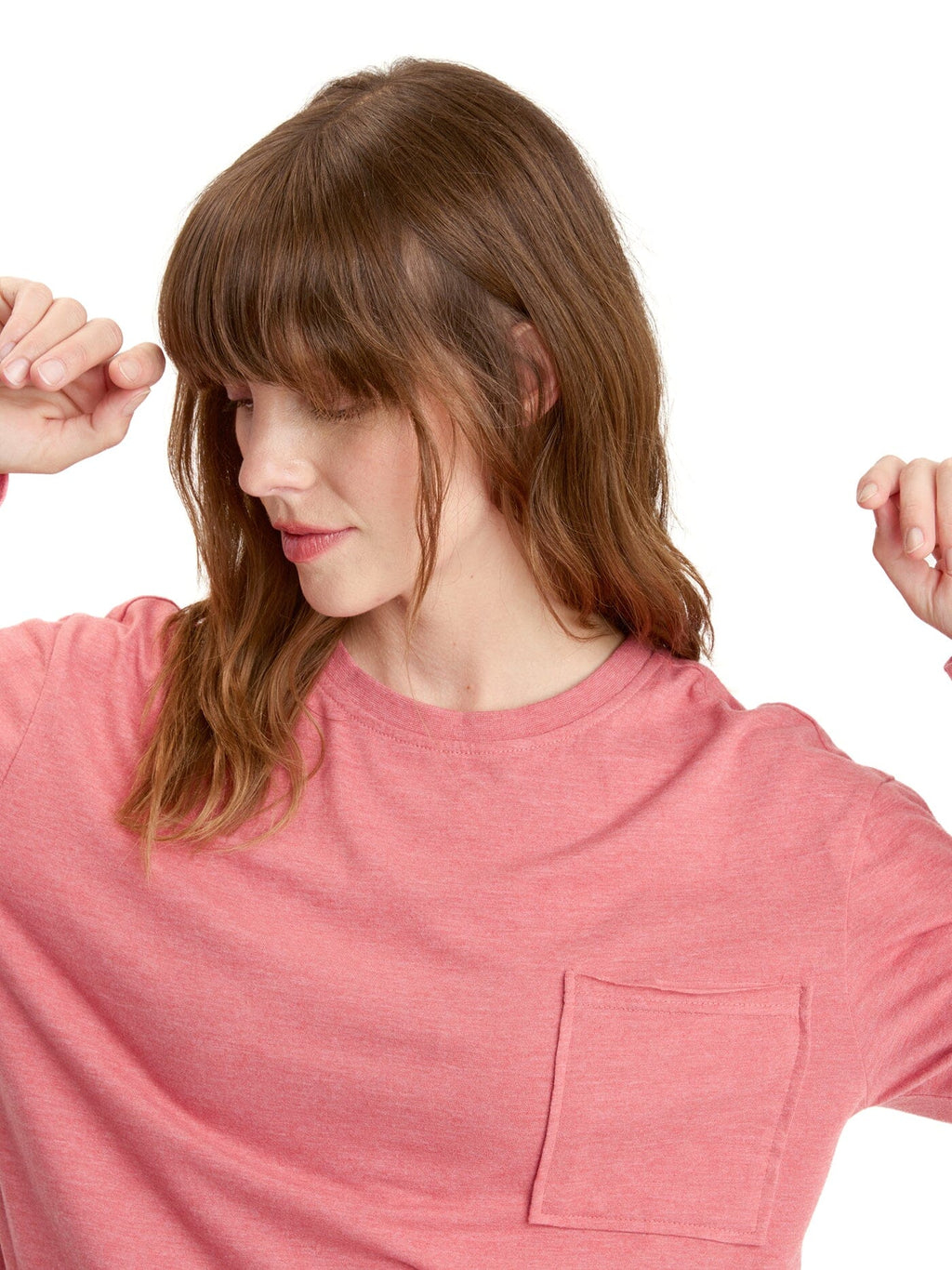 Women wearing a pink long sleeve Maggie pocket tee tucked into high-waist jeans