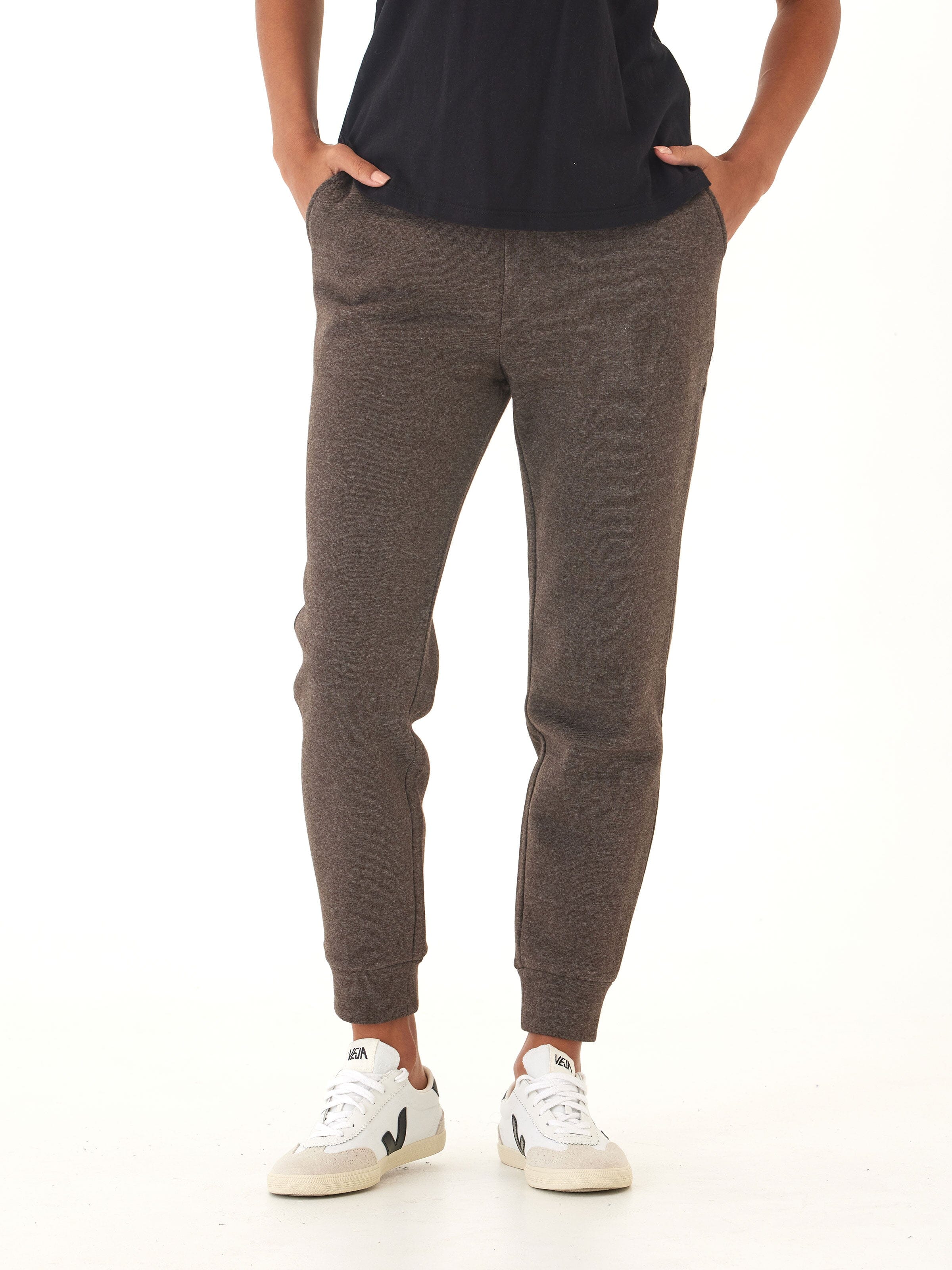 Woman wearing comfortable brown triblend fleece joggers with a thick elastic waistband.