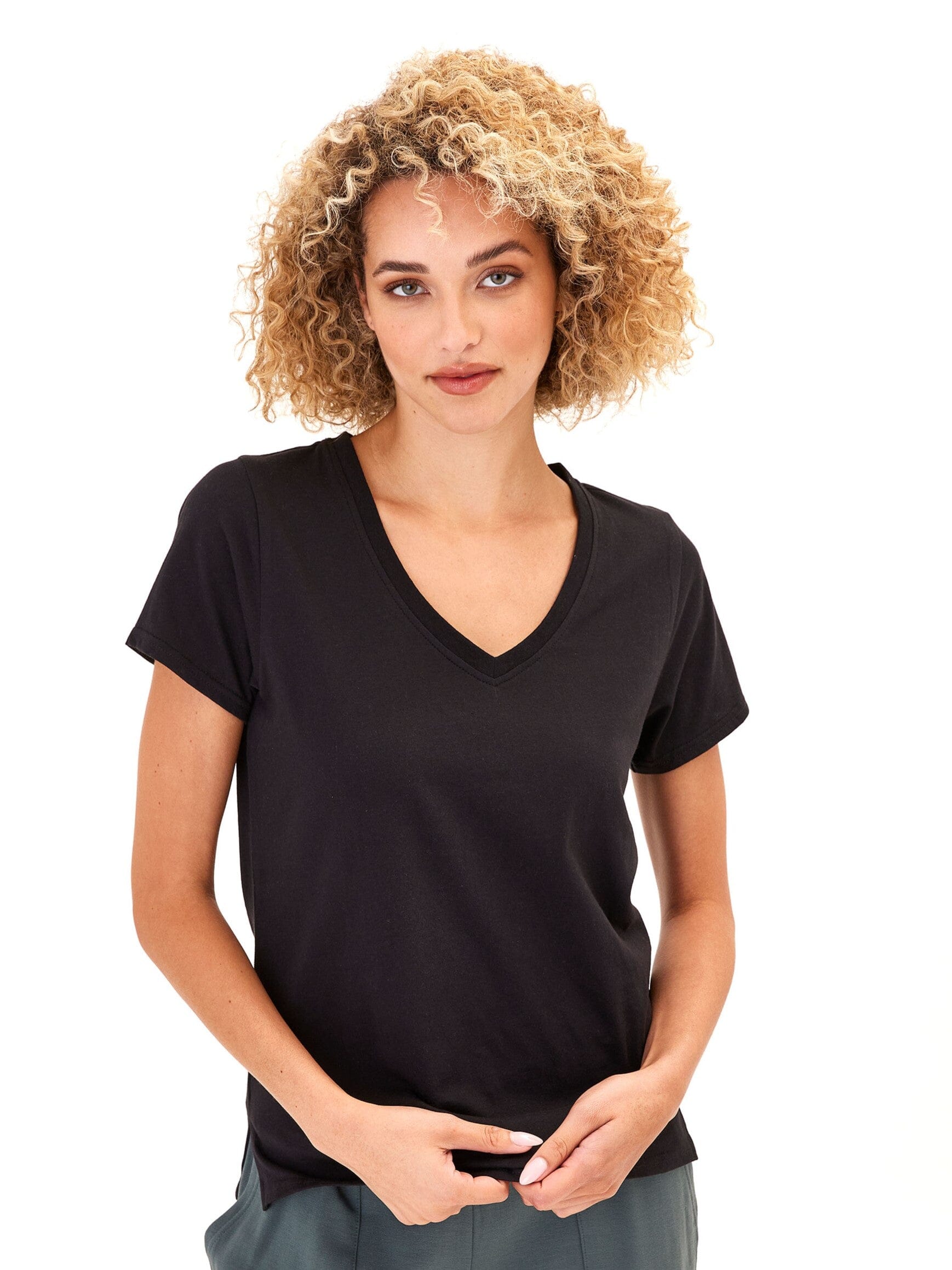 Woman wearing a classic black Pattie organic cotton V-neck tee with a minimalist aesthetic