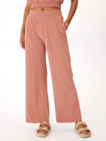 Woman wearing Sharie Towel Terry high-rise wide leg pants in dusty-rose, styled for a relaxed loungewear look.