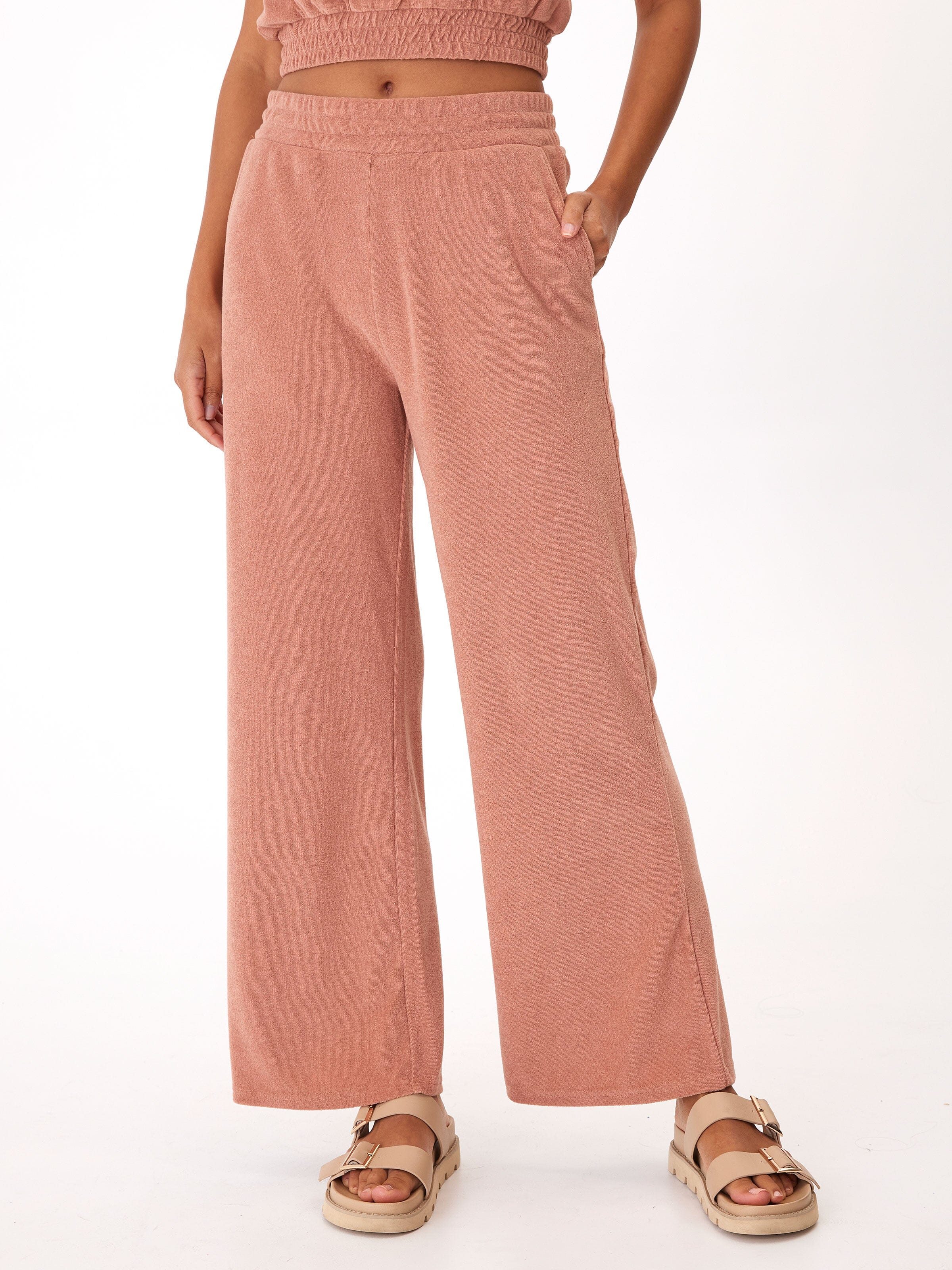 Woman wearing Sharie Towel Terry high-rise wide leg pants in dusty-rose, styled for a relaxed loungewear look.