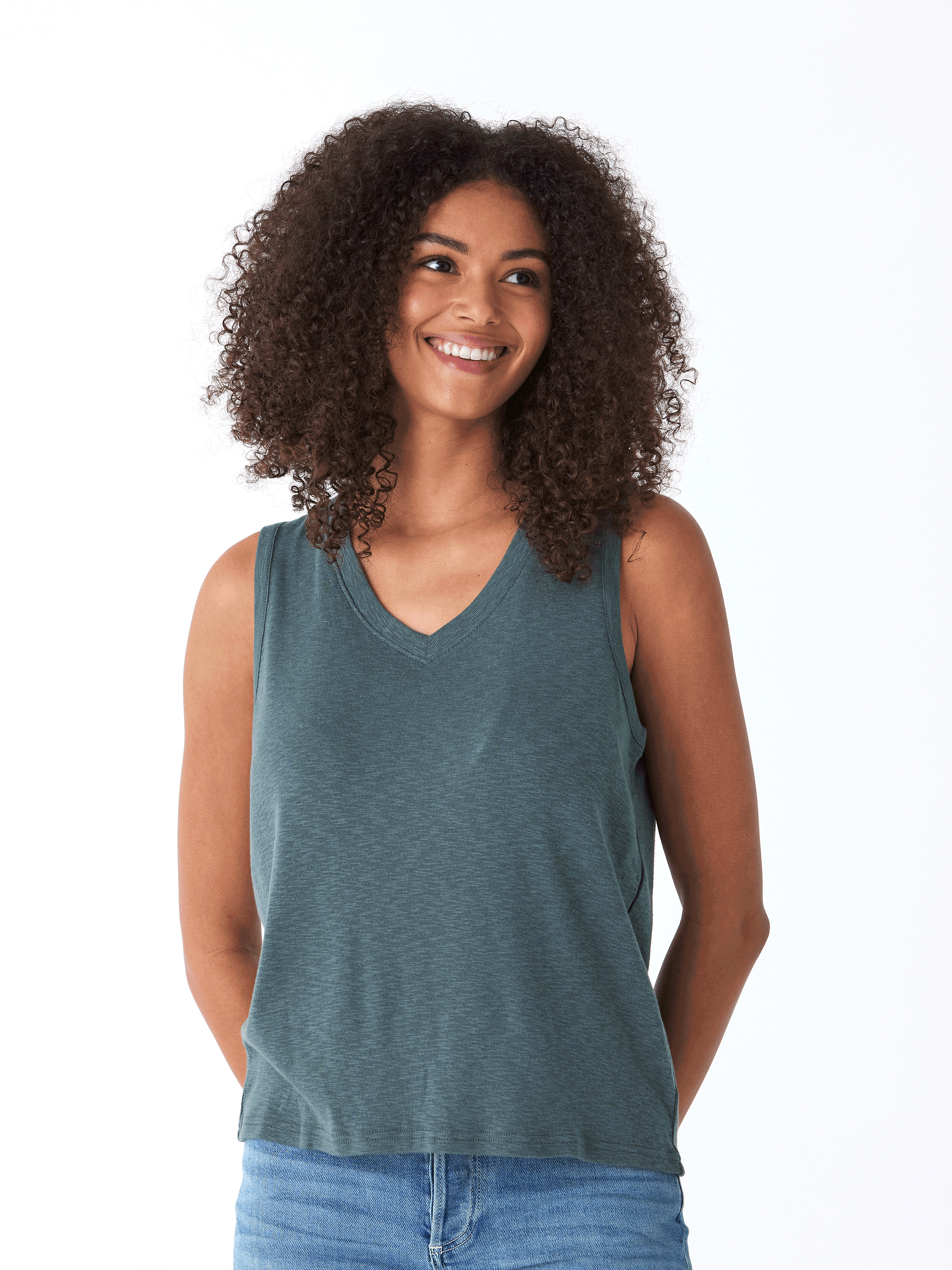 Woman wearing a teal V-neck Kinsley Textured Slub Jersey Top with minimalist aesthetic