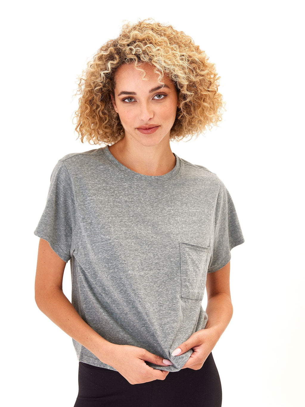 Close-up of a heathered medium grey relaxed fit knit pocket tee with a crew neckline.