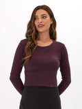 Woman wearing a Guadalupe Luxe Rib Long Sleeve Crop Tee in dark plum minimalist style