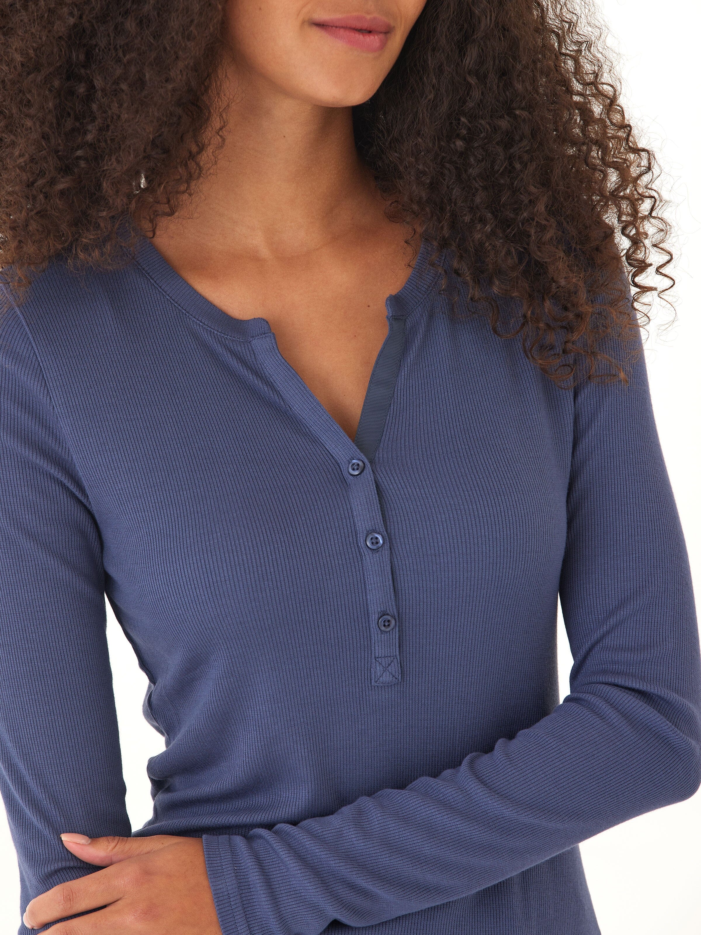Blue Akia Feather Fleece Long Sleeve Henley with functional buttons, shown in a minimalist flat lay