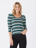 Woman wearing a fitted 3/4-sleeve tee with forest green, cream, sage blue, and maroon stripes and a scoop neckline.