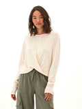 A long sleeve textured jersey top featuring a flattering twist-front detail in a relaxed fit.