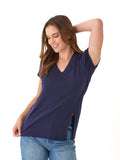 Woman wearing a navy blue V-neck slub jersey tee with side slits and a relaxed fit