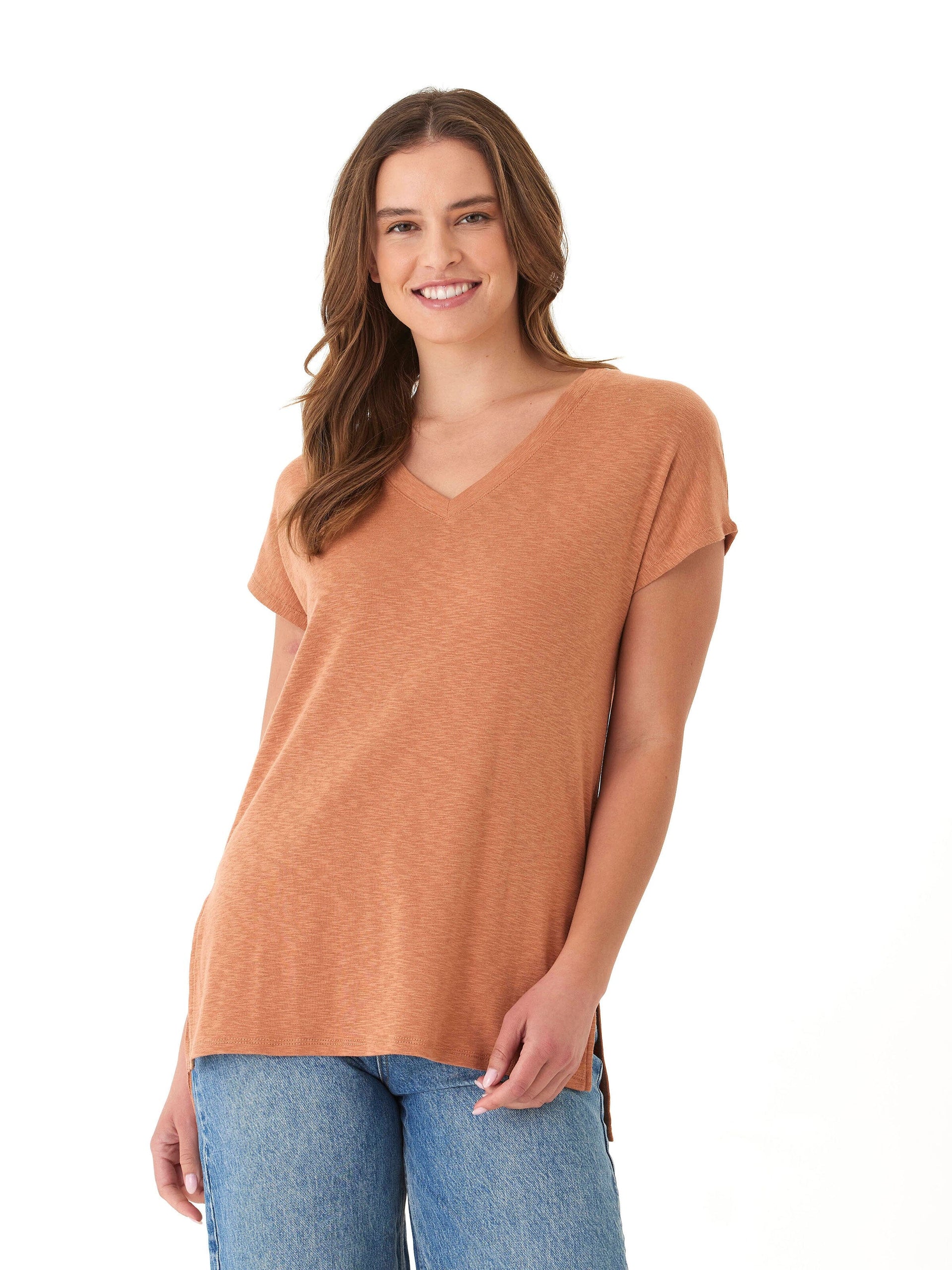 A woman wearing a relaxed fit Elsie textured slub jersey V-neck tee with side slit detail