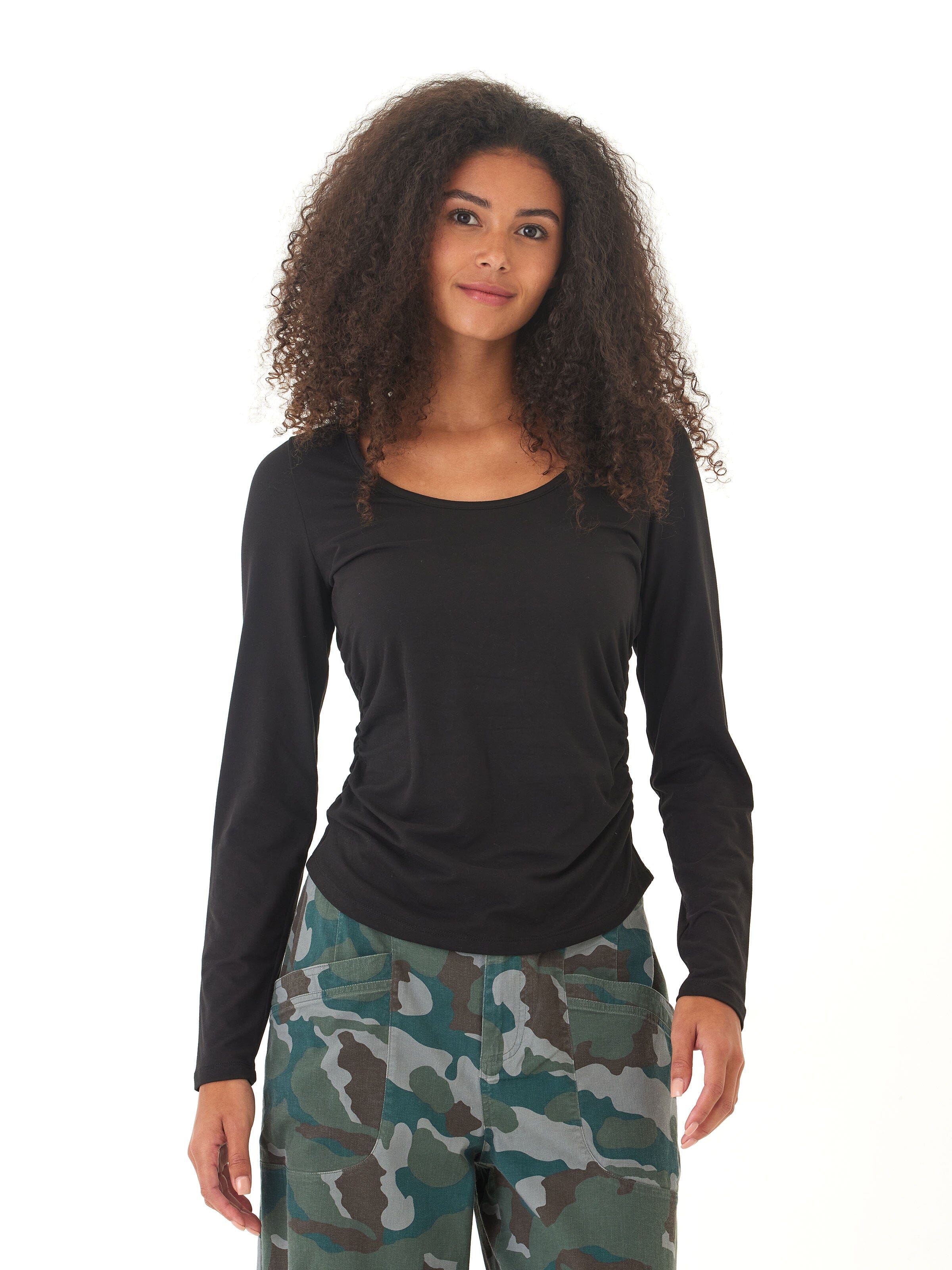 Close up of the Lucia Luxe Jersey Ruched Long Sleeve in black showing the textured side ruching detail.