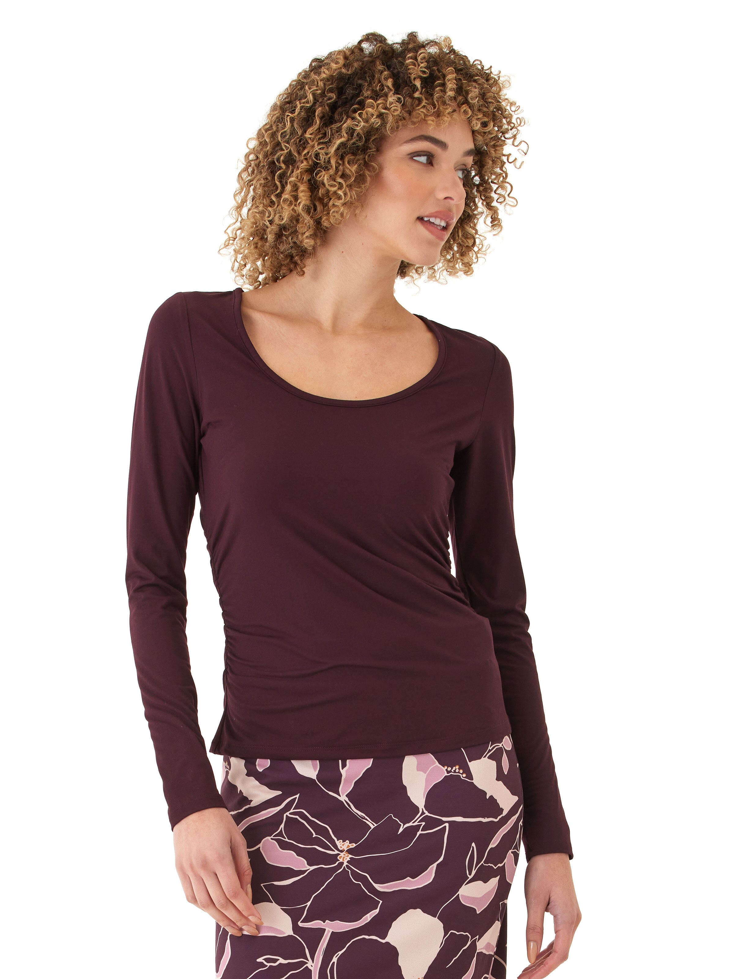 Woman wearing a burgundy Lucia Luxe Jersey ruched long sleeve top