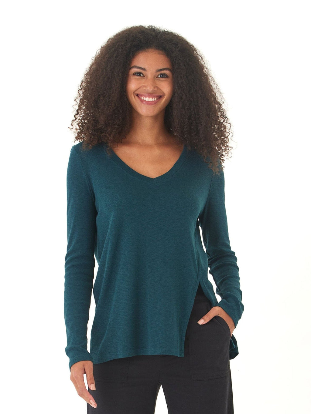 Woman wearing Agatha textured slub jersey V-neck long sleeve top in teal with side slits