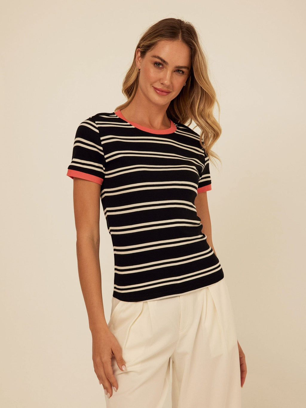 A close up of the Arleen Barbados striped ringer tee in black, white, and coral feather rib knit.