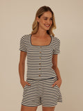 Close up of Jamila smocked jersey short sleeve top featuring square neckline and natural button details