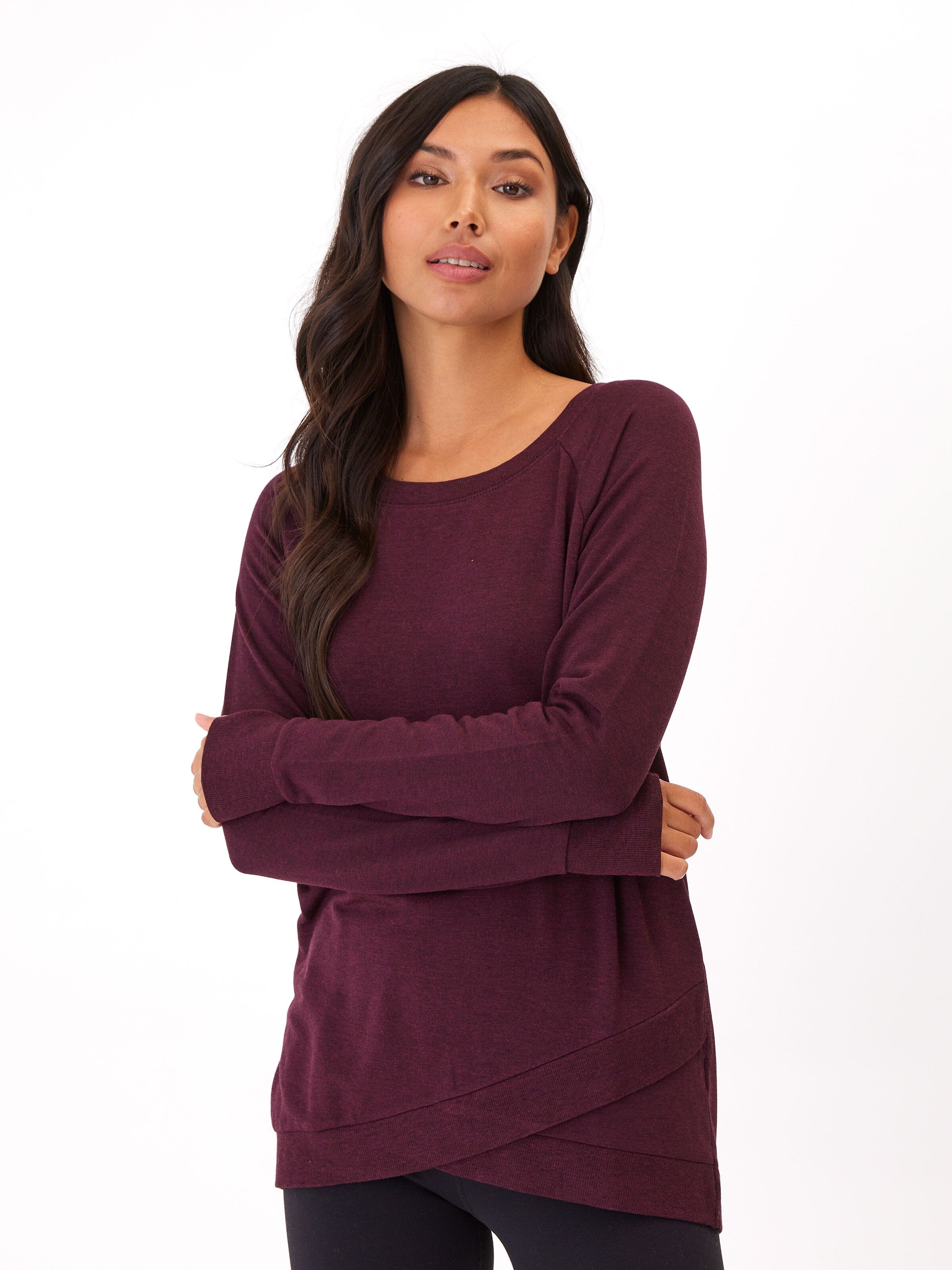 Women wearing a solid burgundy Leanna tulip-hem tunic in brushed TENCEL Modal fleece.
