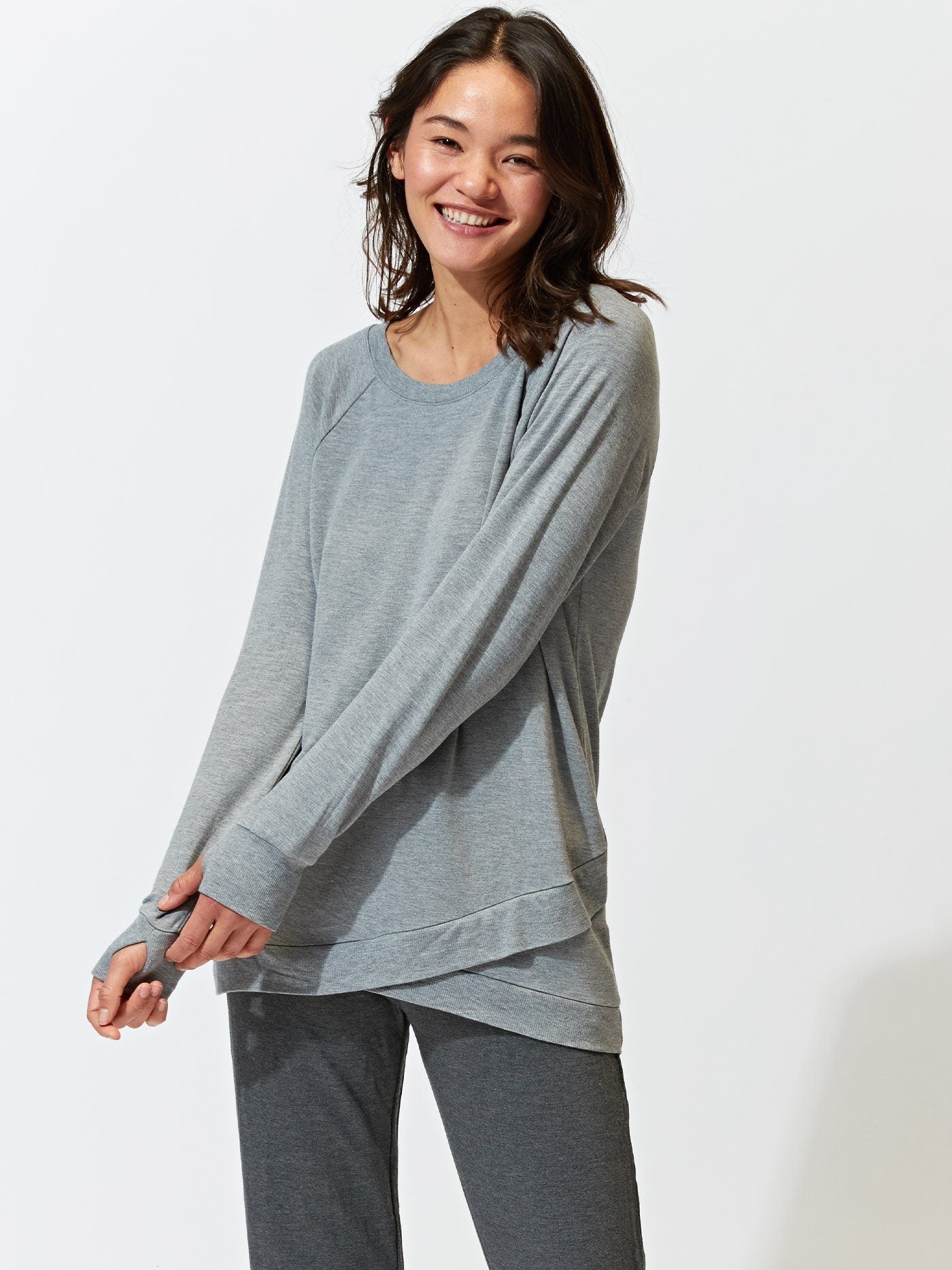 Leanna Feather Fleece Tunic in grey, featuring a tulip-hem, styled with casual leggings.