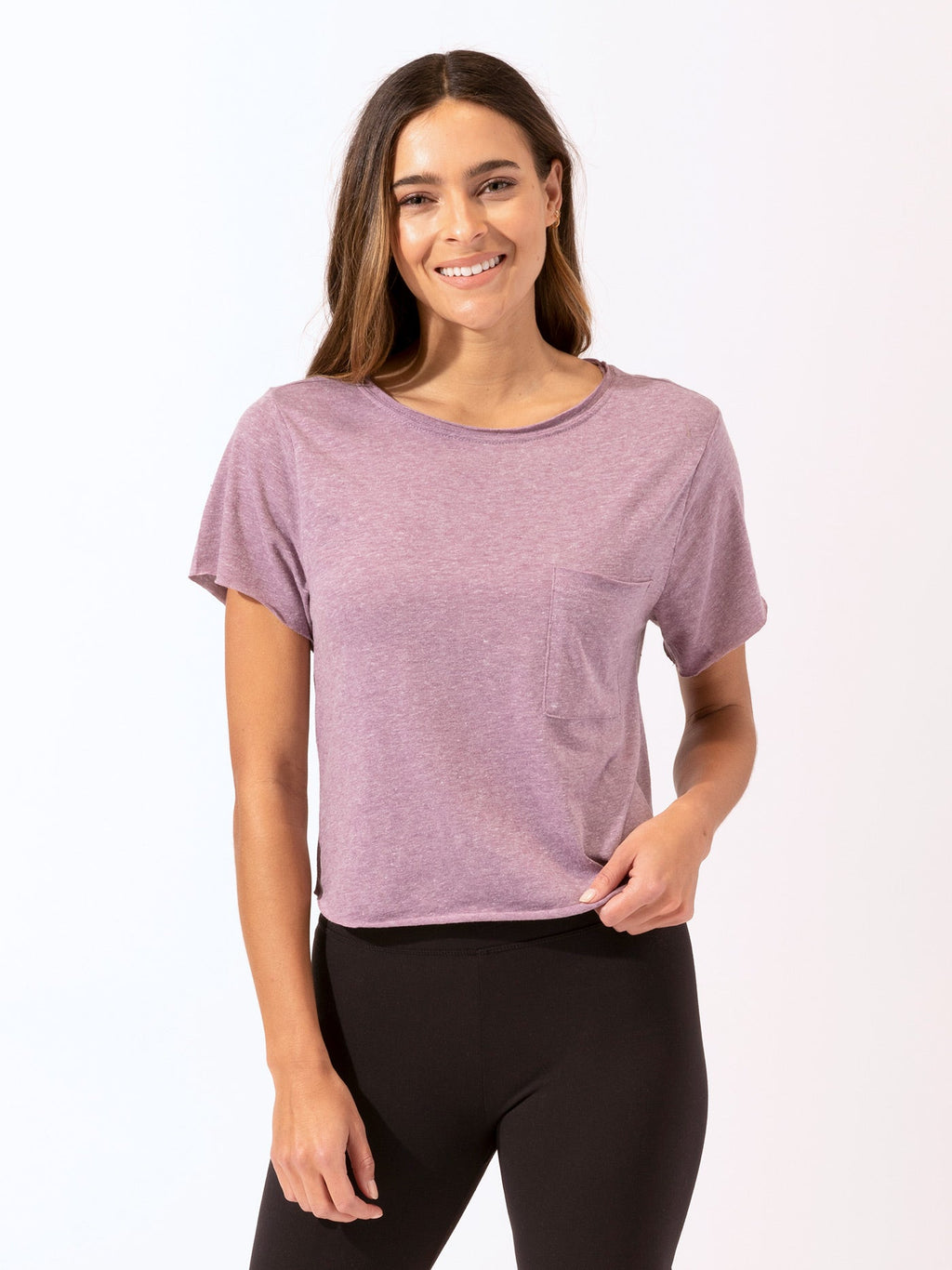 Woman wearing a solid color Maggie Triblend Tee in purple, styled for a casual minimalist look.