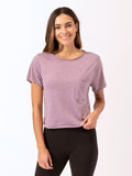 Woman wearing a solid color Maggie Triblend Tee in purple, styled for a casual minimalist look.