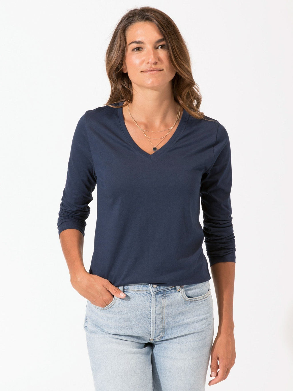 Women's Invincible navy blue long sleeve V-neck tee with a relaxed, minimalist fit
