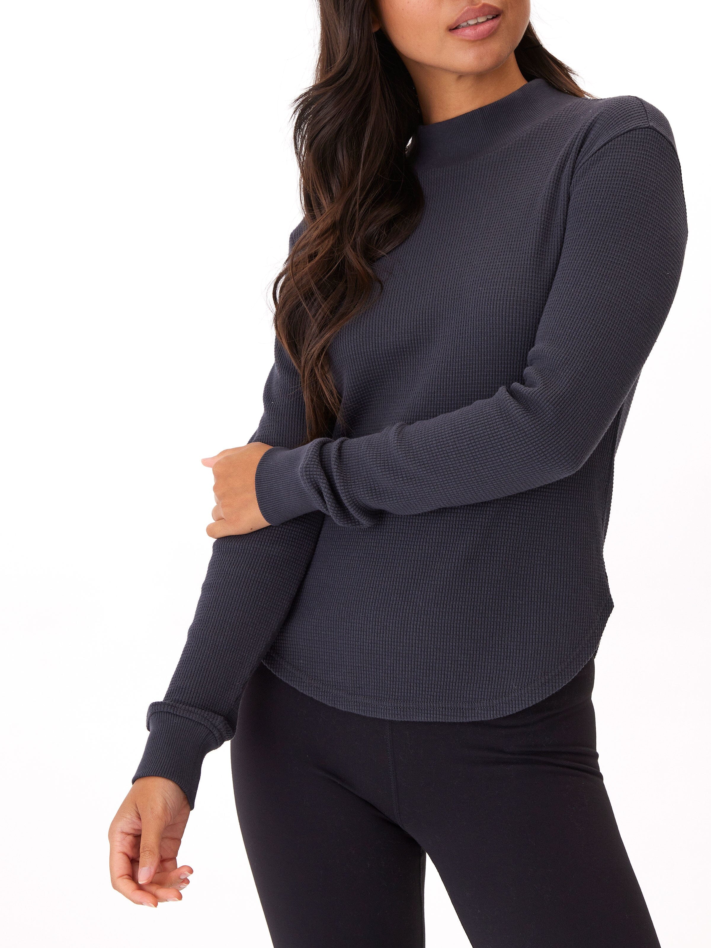 Close up of the Haidee Mock Neck Top in a waffle knit fabric with ribbed detailing