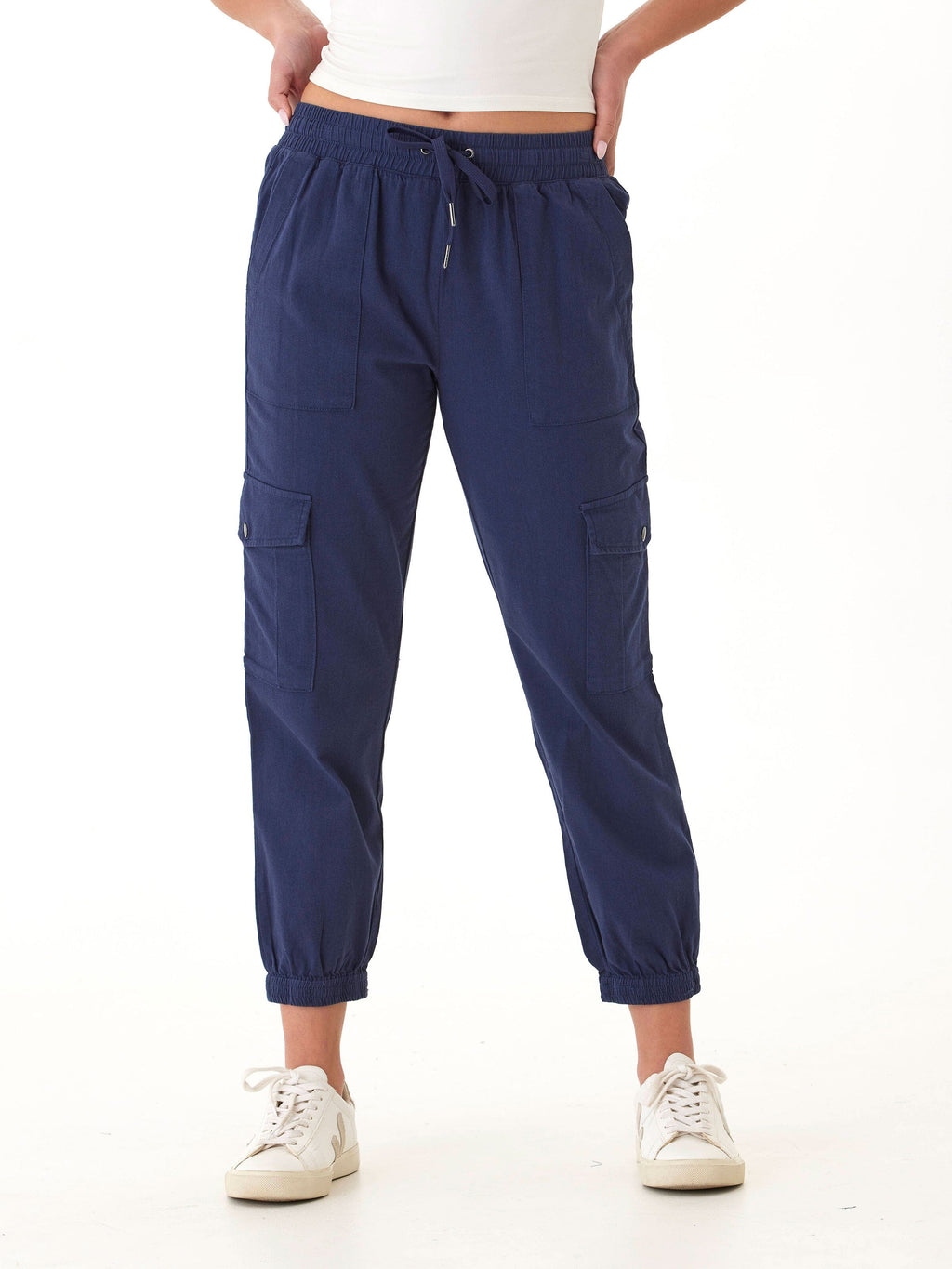 Women wearing navy blue Delilah stretch twill cargo joggers with side snap pockets and elastic waist