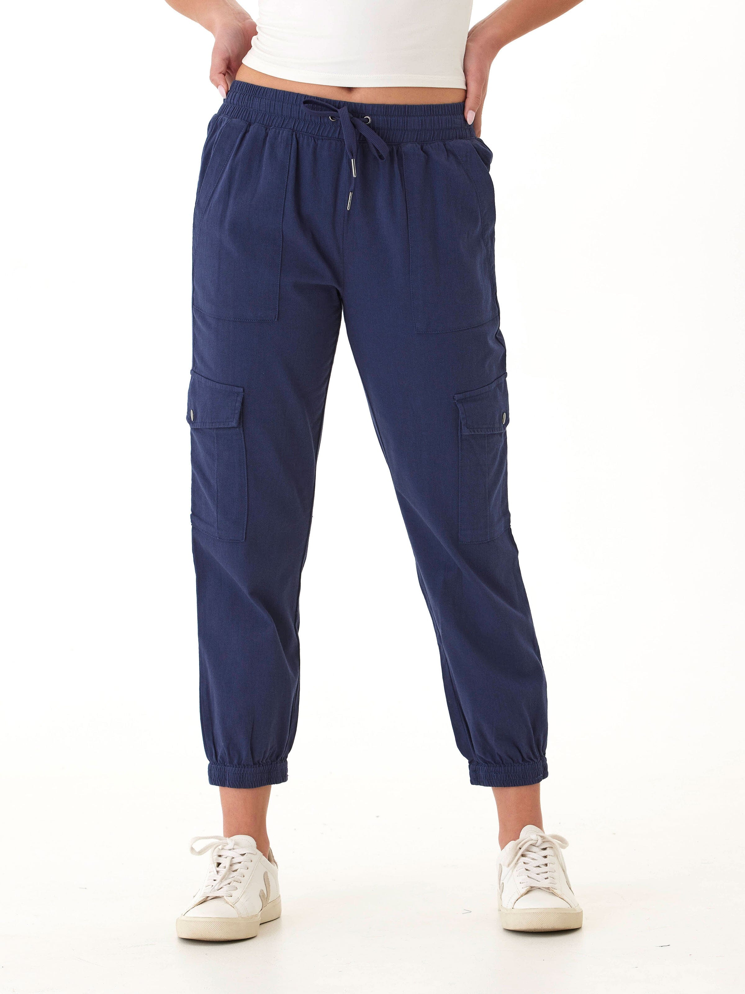 Women wearing navy blue Delilah stretch twill cargo joggers with side snap pockets and elastic waist