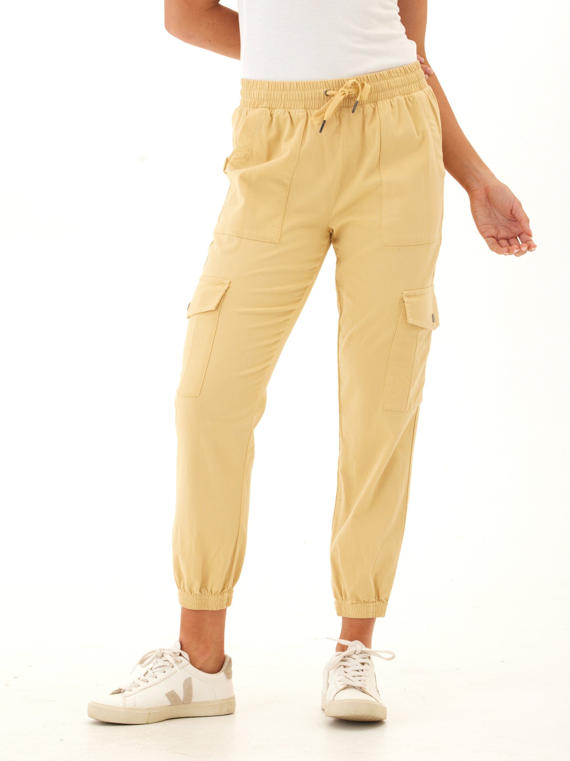 Woman wearing Delilah Stretch Twill Cargo Joggers in light sandy beige neutral tone with utility pockets