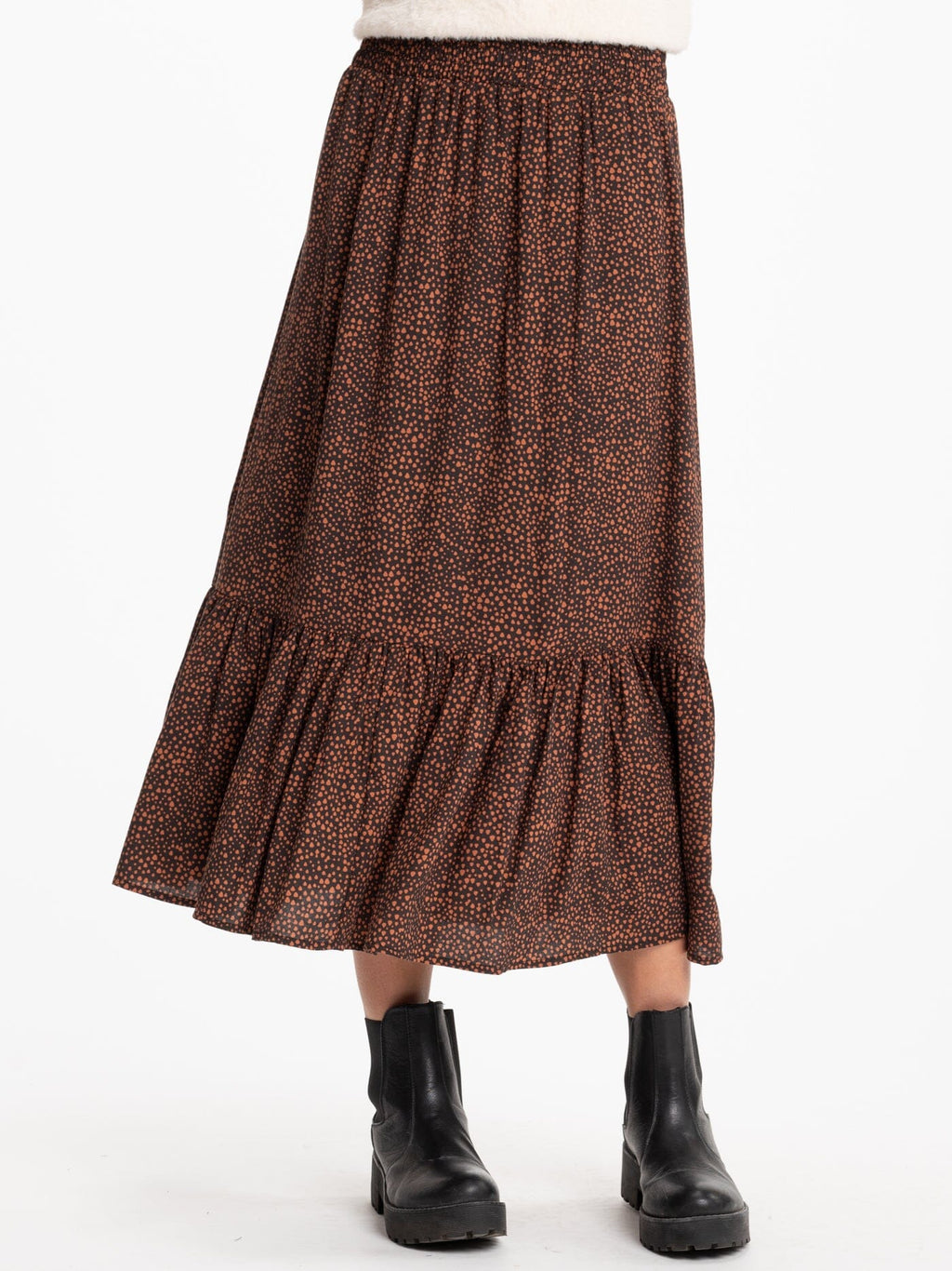 A flowy brown and rust abstract print midi skirt with a tiered design and elastic waistband.