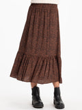 A flowy brown and rust abstract print midi skirt with a tiered design and elastic waistband.