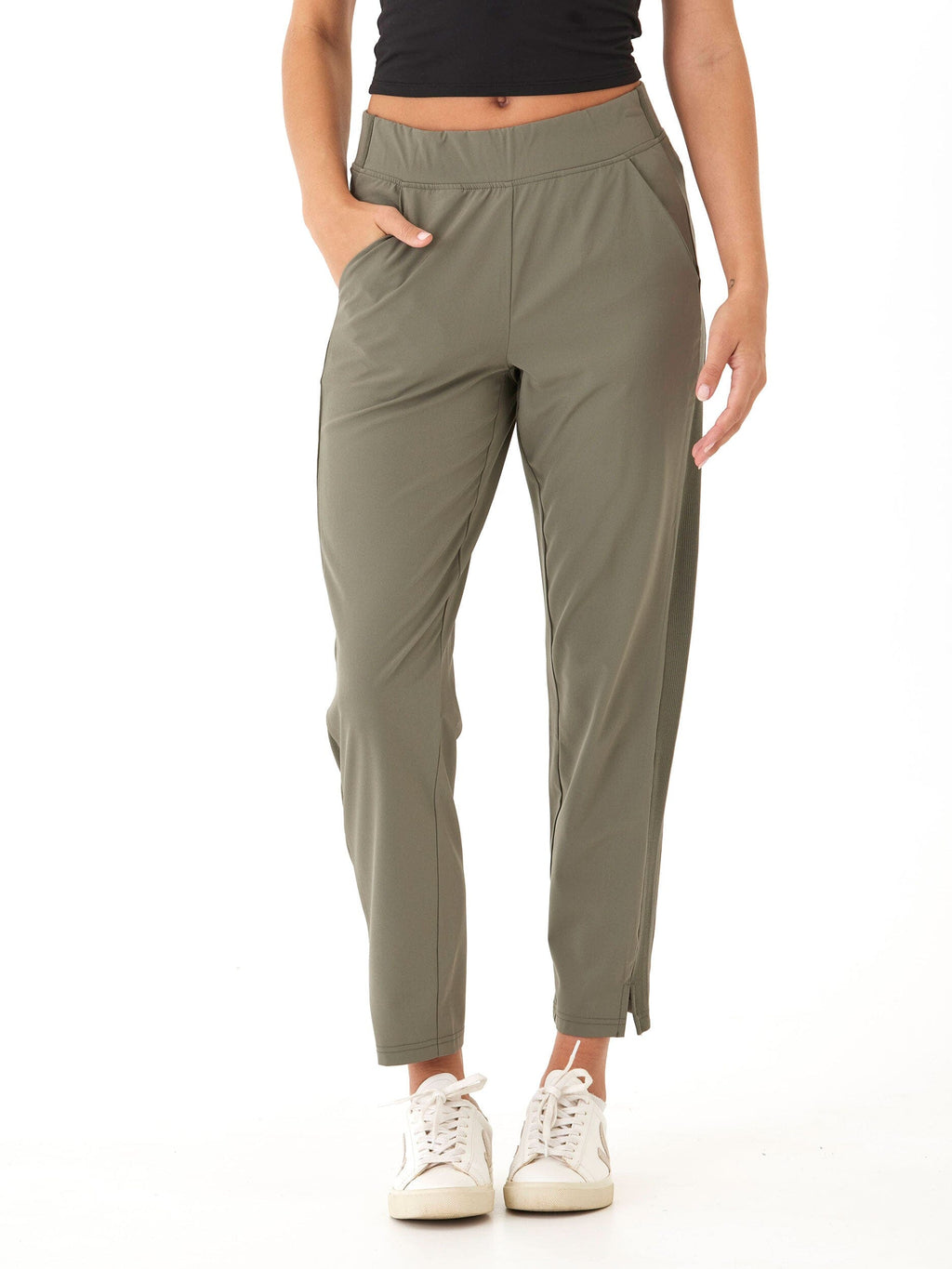 Model wearing Leticia Performance Rib Mix Pant in muted olive green with tapered ankle fit and side panel detail.
