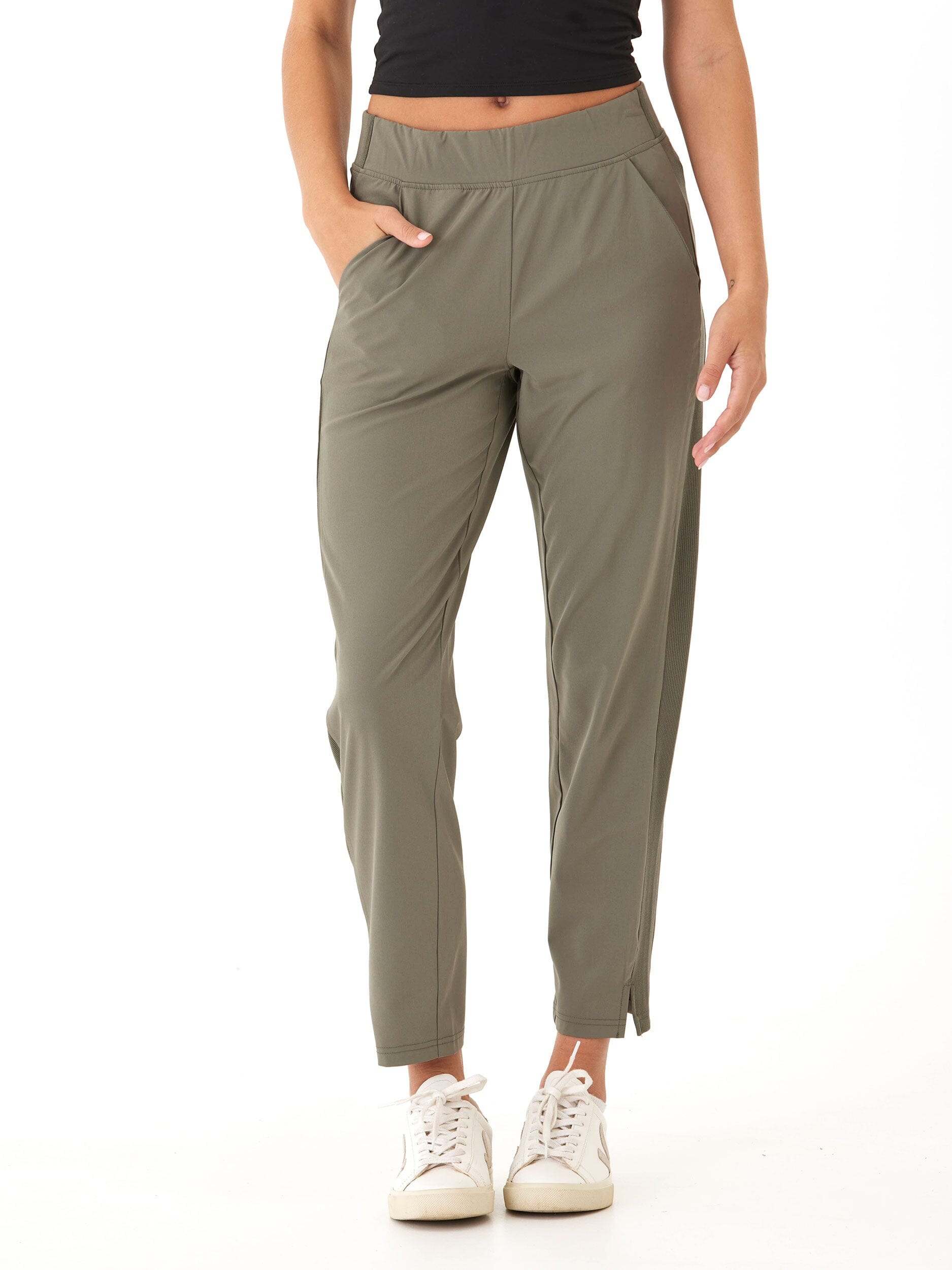 Model wearing Leticia Performance Rib Mix Pant in muted olive green with tapered ankle fit and side panel detail.