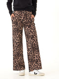 Close up of a woman wearing leopard print stretch twill wide leg pants.