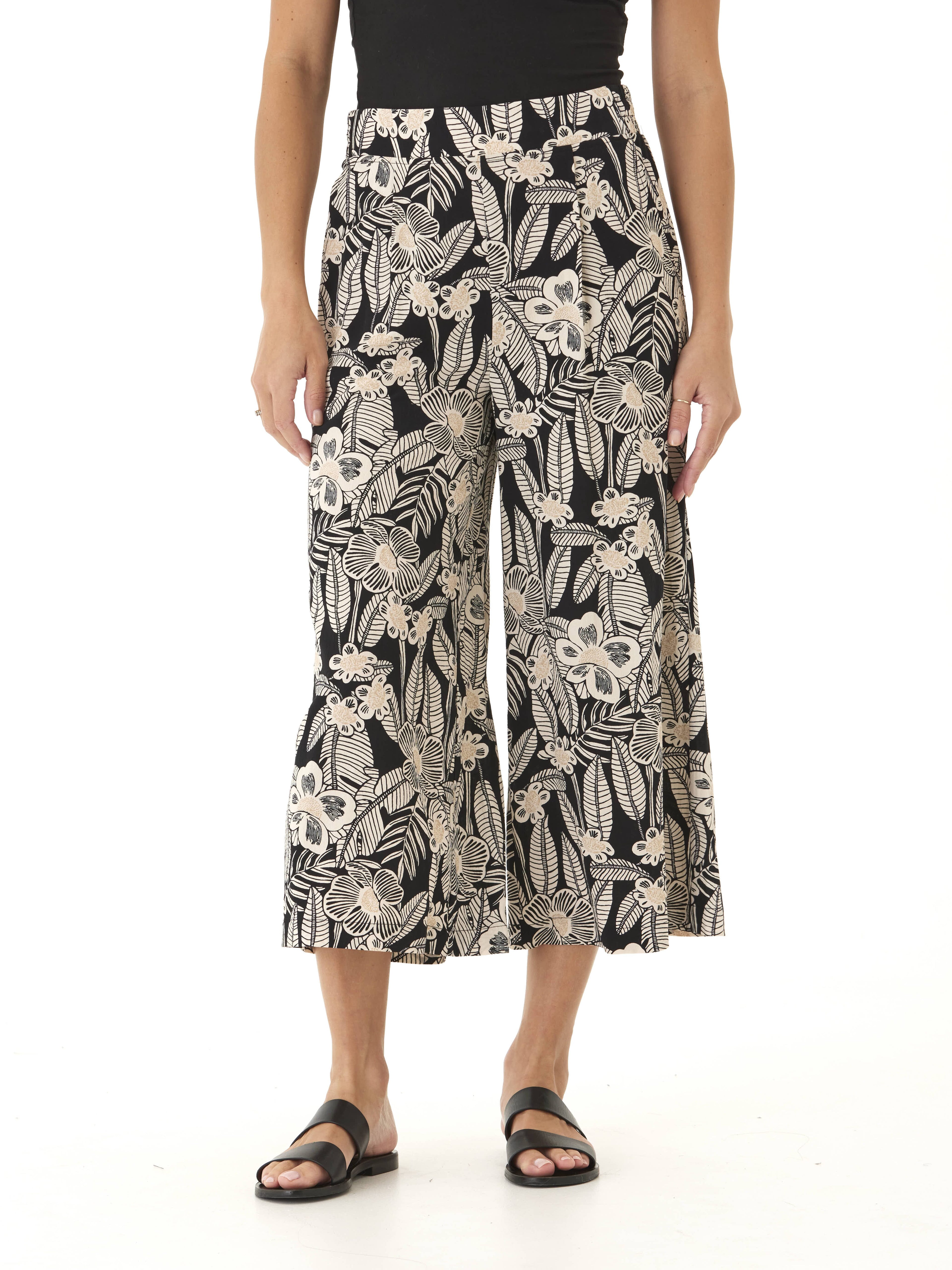 Model wearing Alora Island Flora Print Woven Capri Pant with a cropped wide-leg silhouette and side pockets