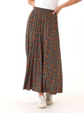 Woman wearing an Anastacia floor-length maxi skirt with a black, orange, and teal floral print in a relaxed A-line silhouette.
