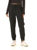 A pair of solid matte black Trysha Ultrastretch Woven Joggers with a tapered silhouette and pull-on elastic waistband.