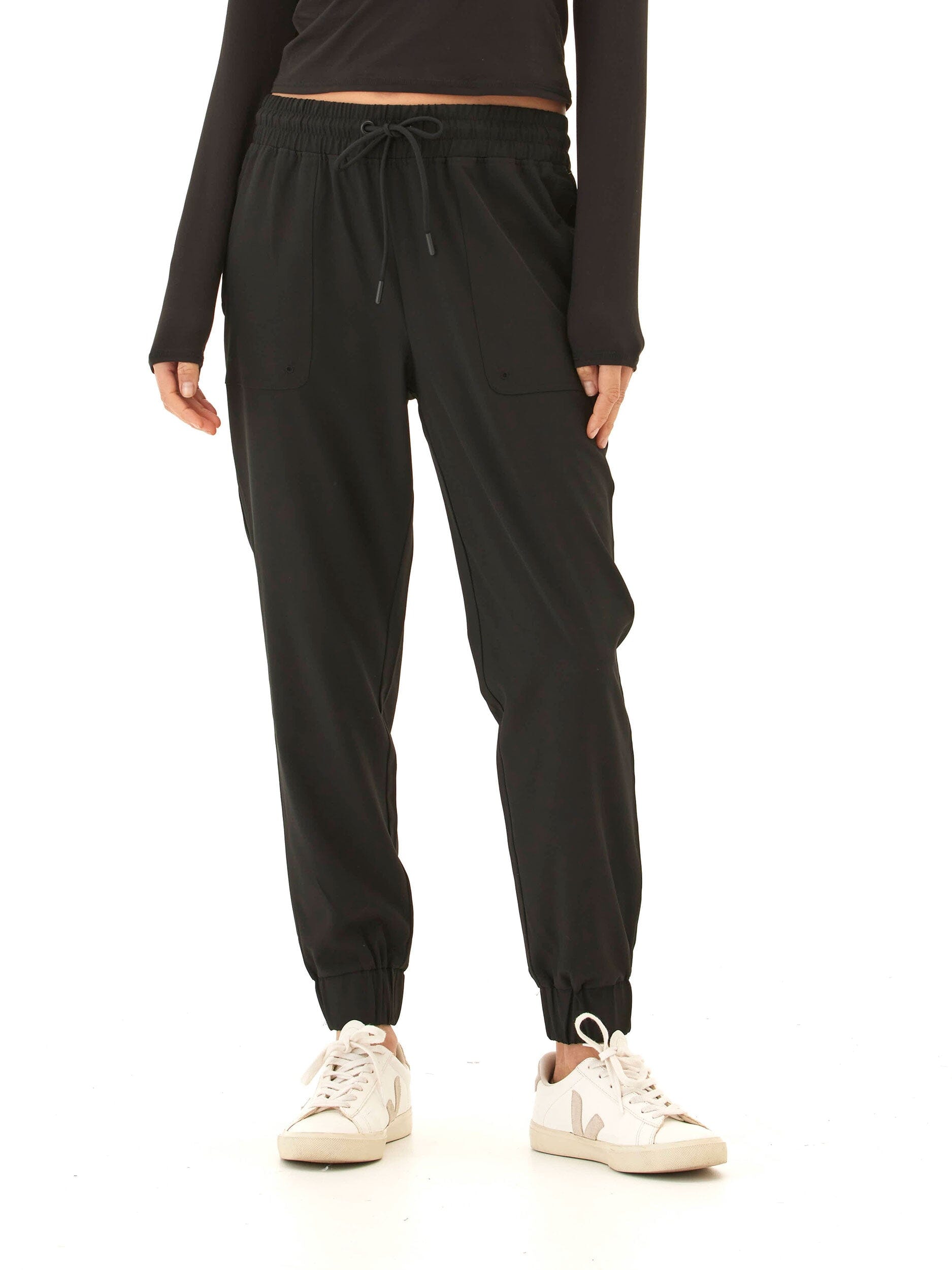 A pair of solid matte black Trysha Ultrastretch Woven Joggers with a tapered silhouette and pull-on elastic waistband.