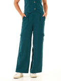 A woman wearing breezy teal wide-leg linen cargo pants with patch pockets in a minimalist style.