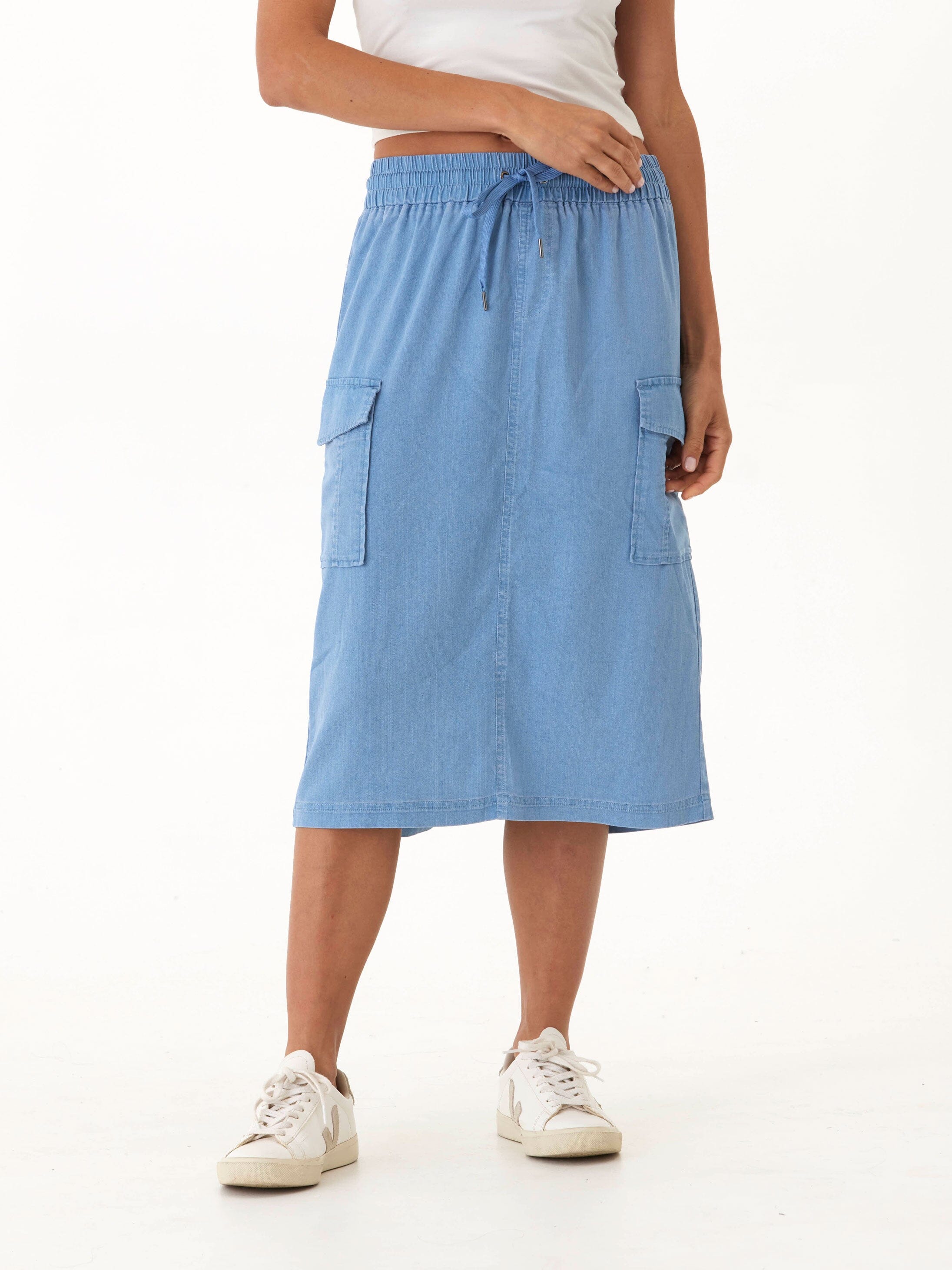 Front view of light blue stretch denim cargo midi skirt with drawstring waist and patch pockets