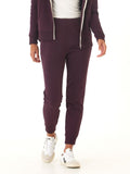 Woman wearing dark purple Rowena Triblend Fleece Joggers with a relaxed, tapered fit.