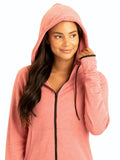 Woman wearing the Sybil FeatherLoop fleece slim fit athletic hoodie in coral