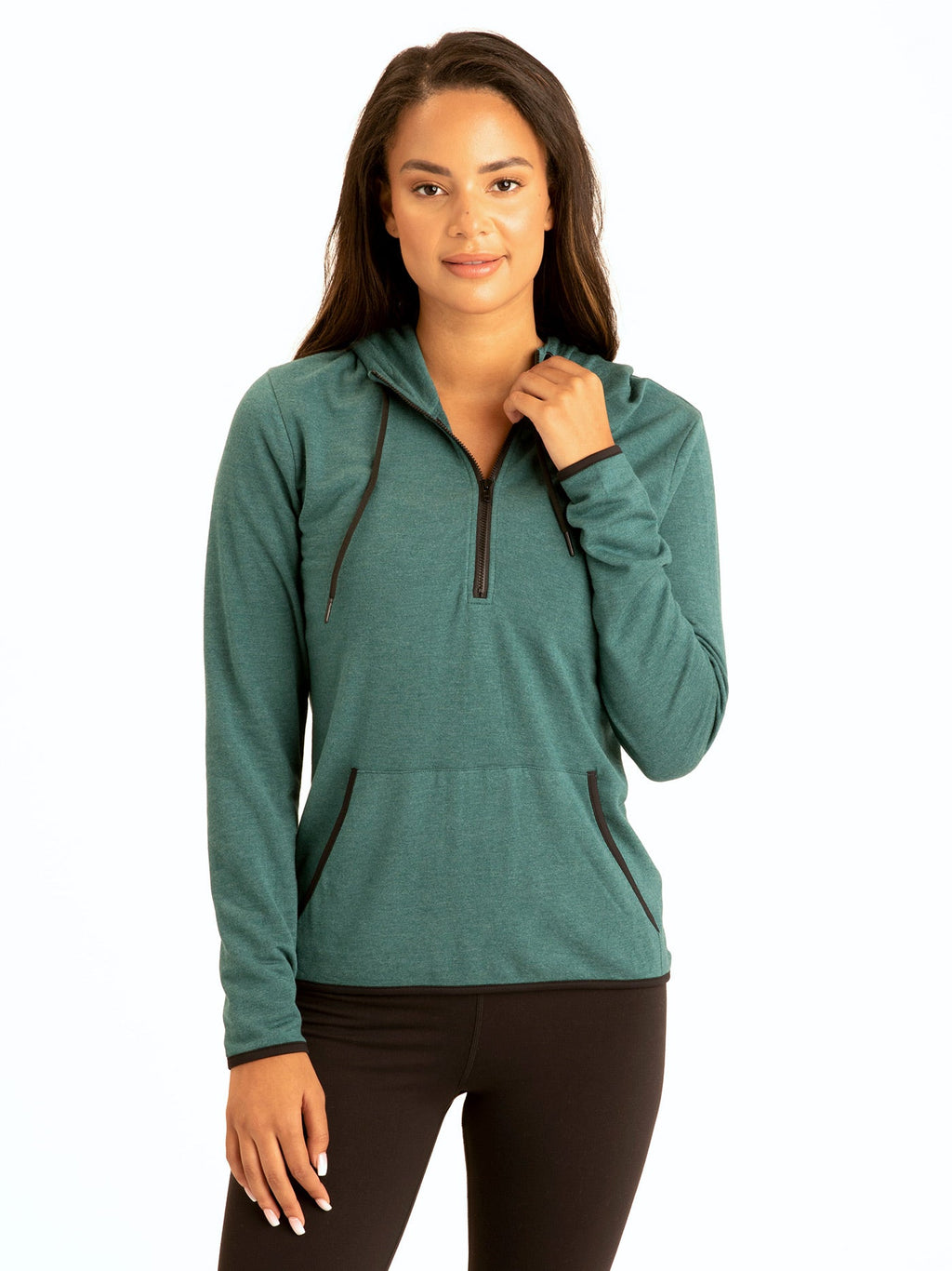 Woman wearing a Kyanna FeatherLoop Half Zip Hoodie in green with a slim fit and pouch pocket.