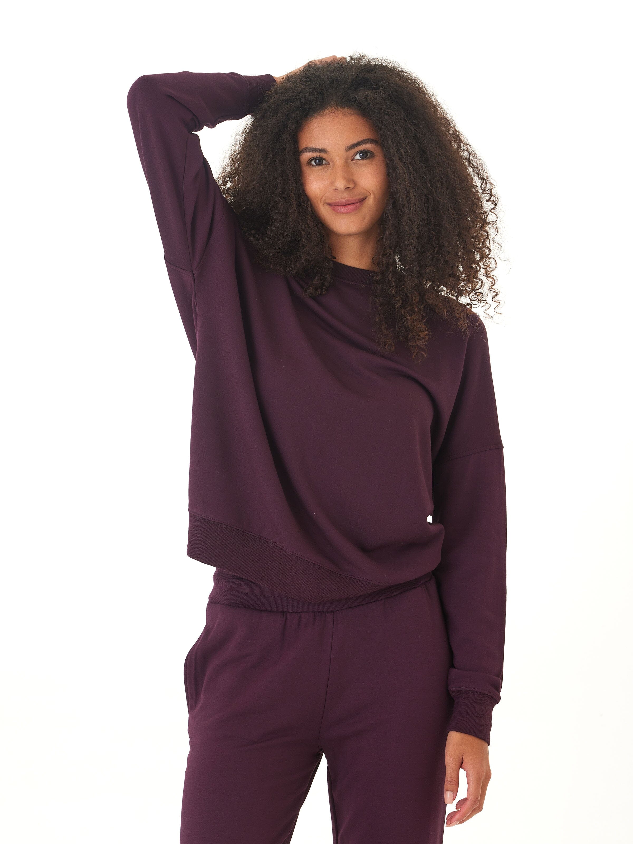 Relaxed fit Core Feather Fleece Sweatshirt in dark purple, shown with a smooth knit finish.