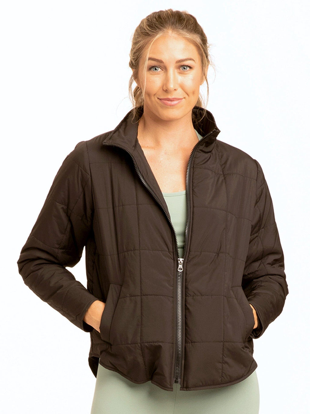 A lightweight Athene Packable Puffer Jacket shown in a travel-ready folded state with a wrist strap.