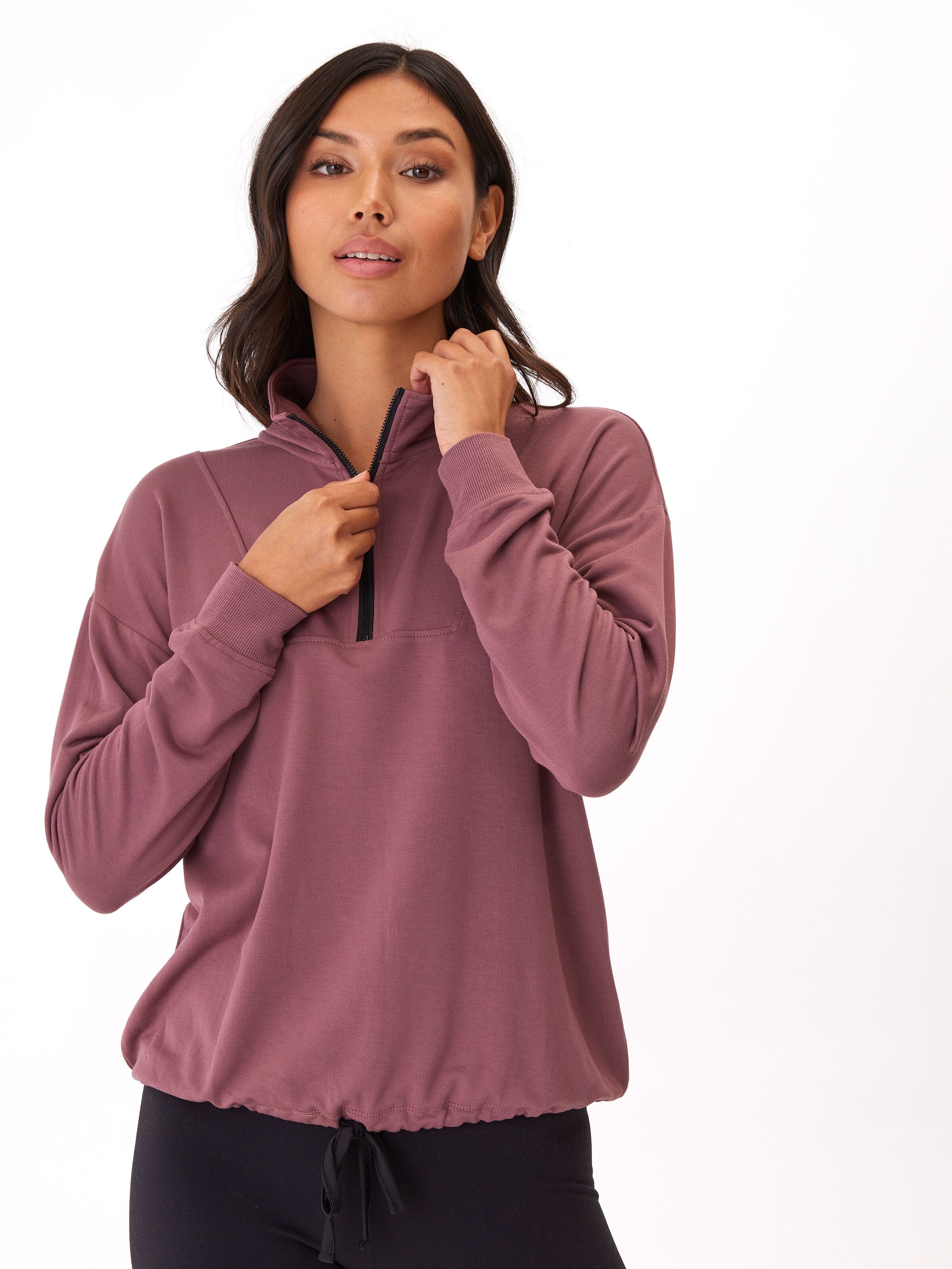 Woman wearing Nyla FeatherLoop Fleece half zip pullover in mauve