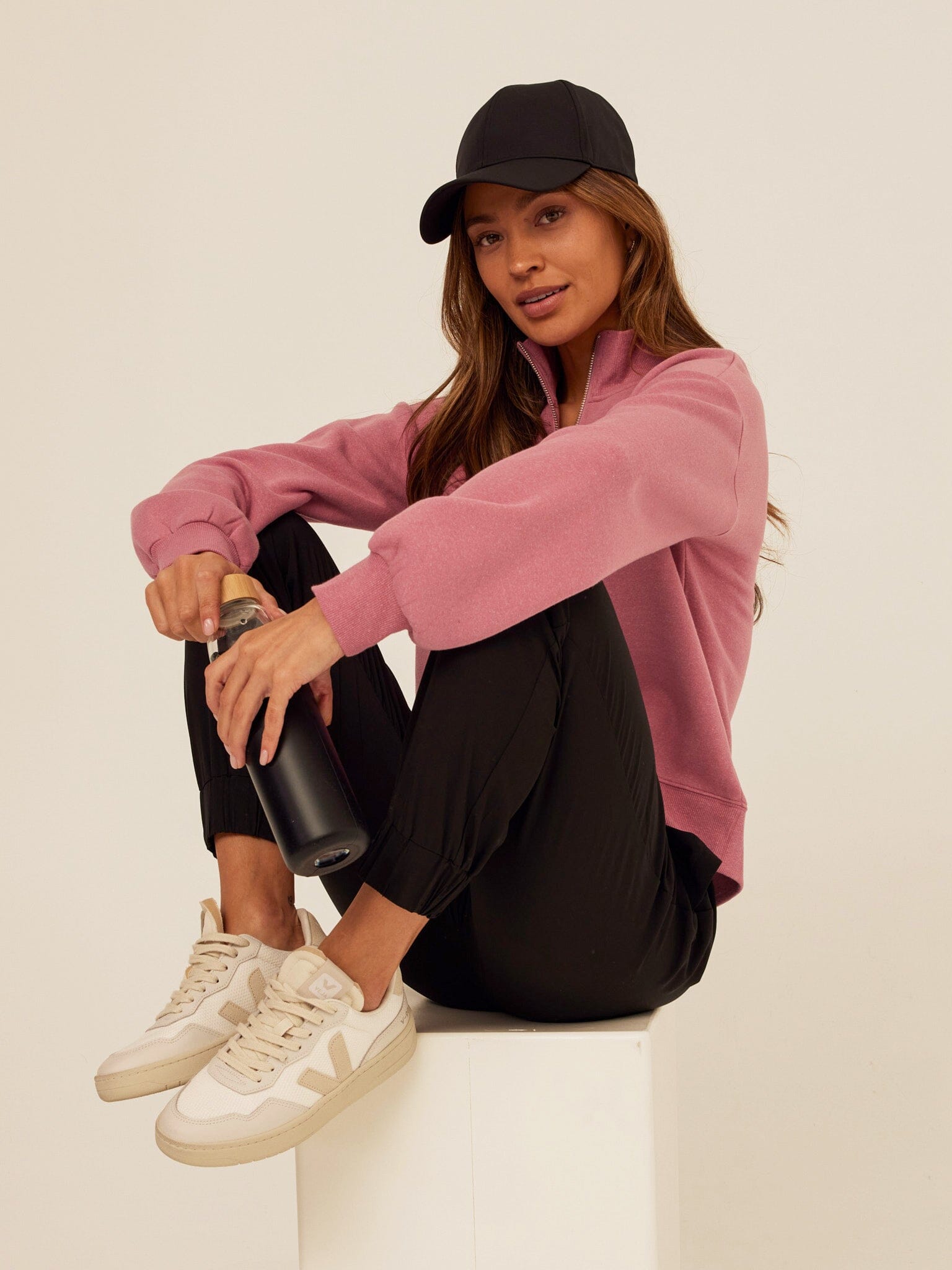 Constance half zip pullover in dusty-rose knit fabric worn with casual attire