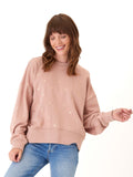 Close up of Naia Metallic Dot Pullover showing metallic dot details and ribbed trim